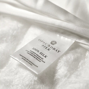 100% Silk care label with the OPSUNDBAY logo on visible silk floss